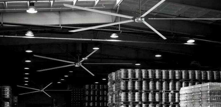 Technician measuring factory dimensions for industrial fan installation