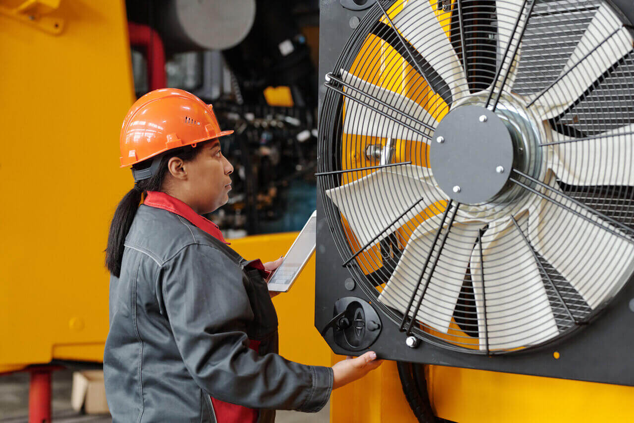 How do industrial fans improve productivity in production facilities?